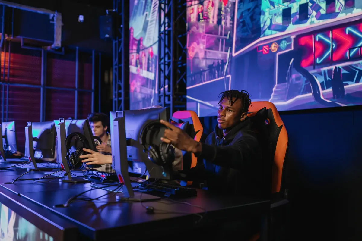 Two gamers intensely focused in a professional eSports competition with vibrant game visuals.